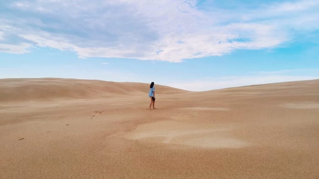 Photo of a person standing in the Stockton Sand Dunes in Port Stephens