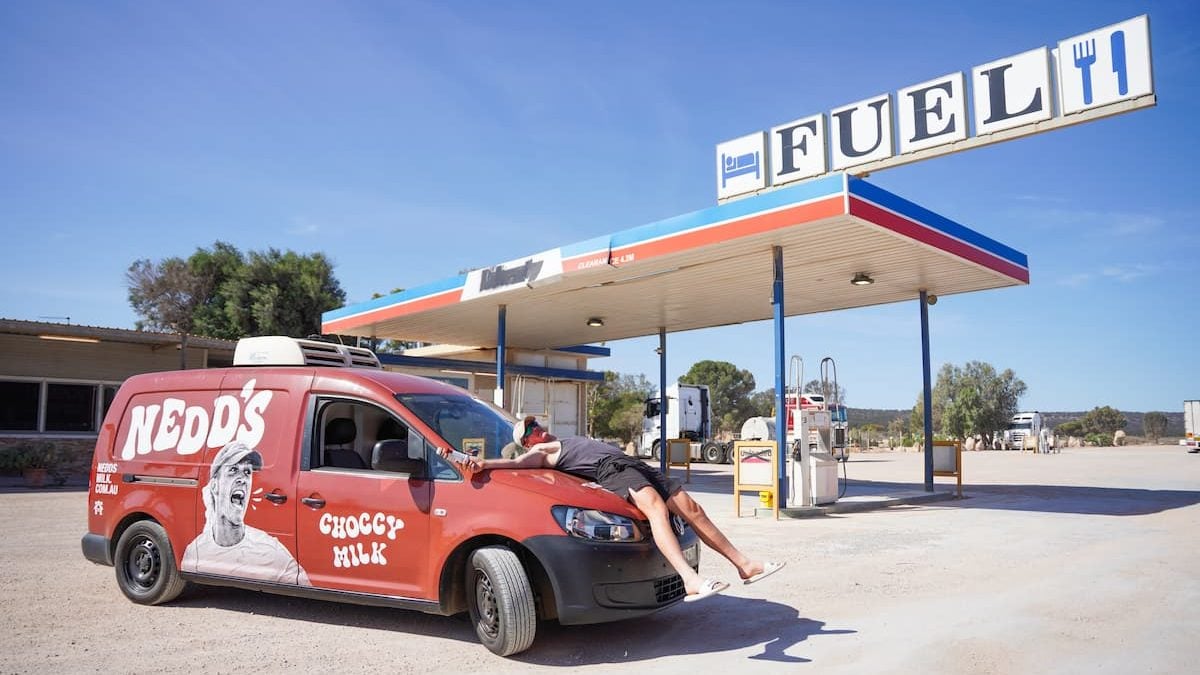 Nedd Brockmann with his van outside a petrol station, during an Australian road trip.