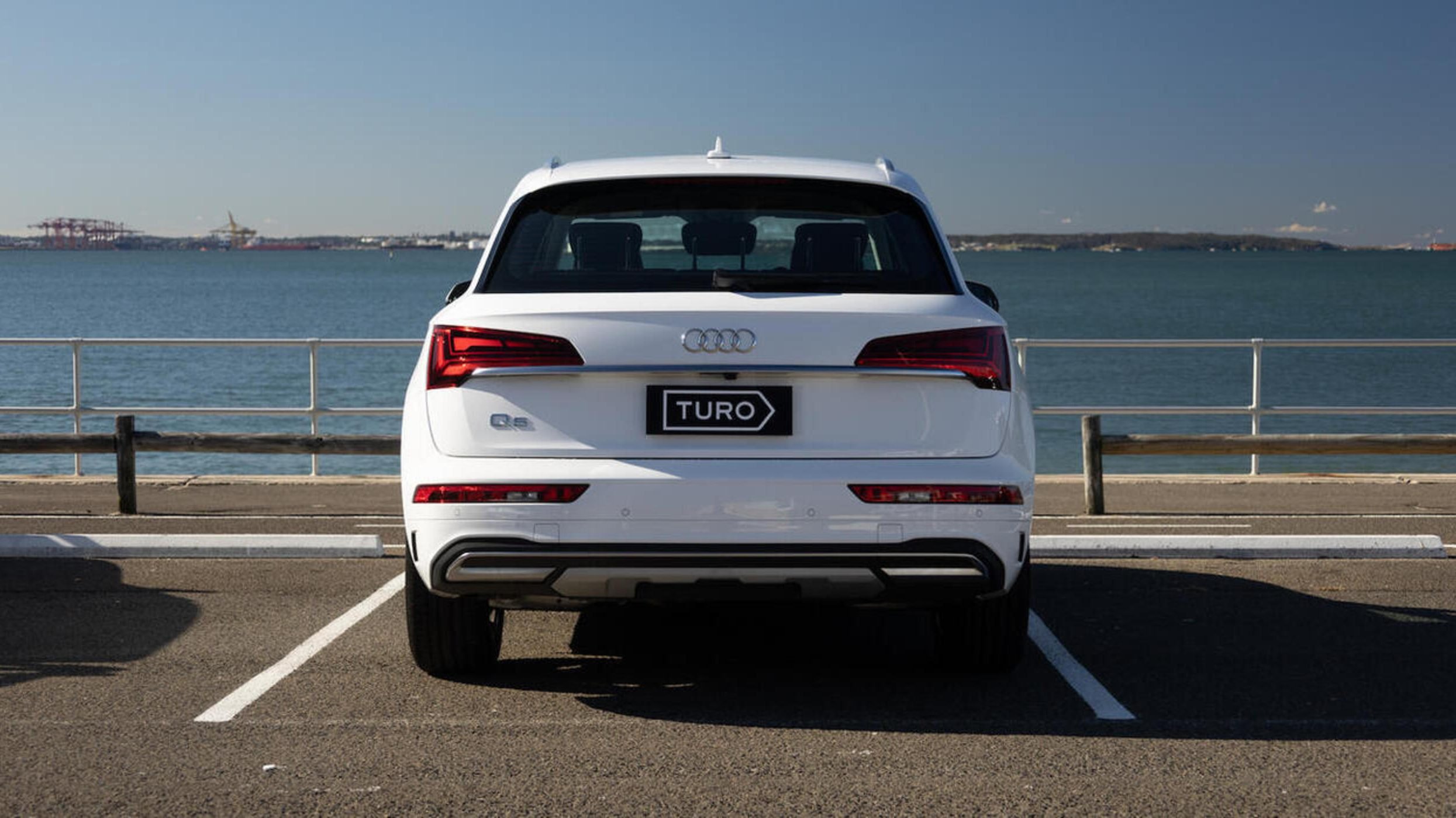 An Audi Q5 parked by the ocean, perfect for a day trip from Perth.