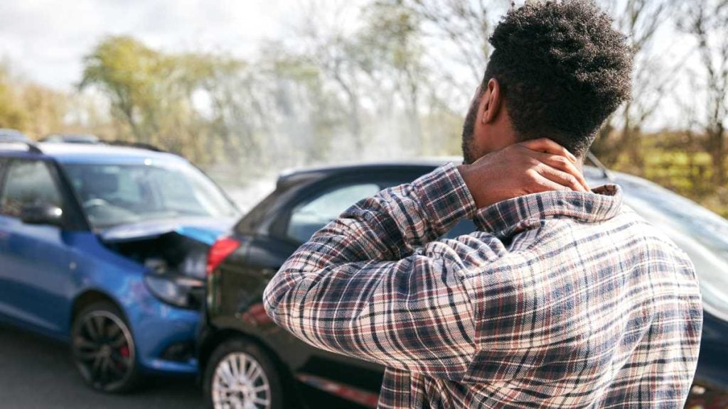 What to do when you are involved in a crash while driving in Canberra, Australia. Picture shows a person stressed after a road accident.