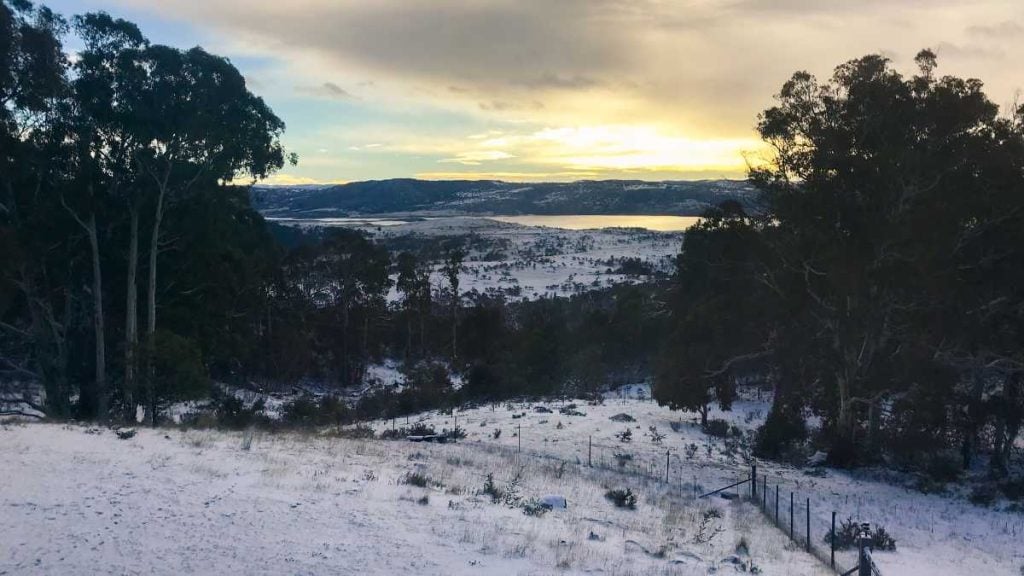 View of Jindabyne lake from a distance, on a snowy winter day