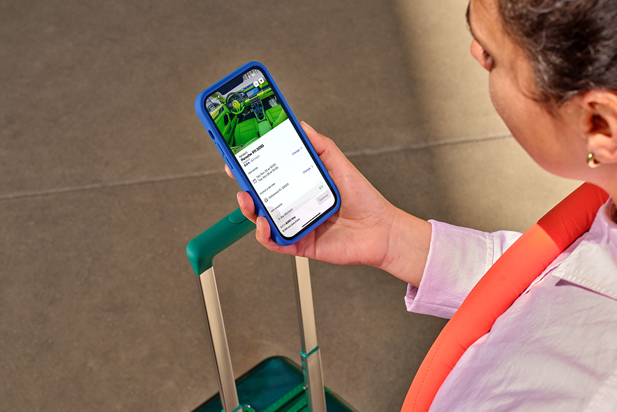 A woman browses vehicles with the Turo app on her phone.