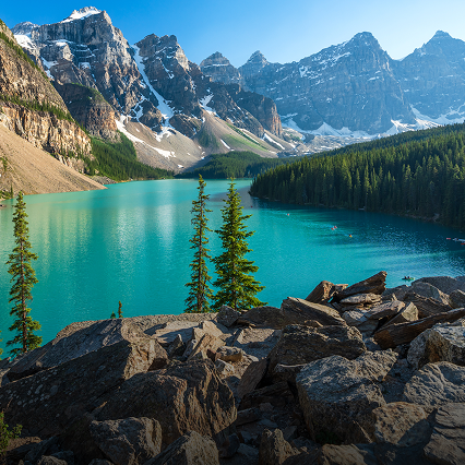 A beautiful, still lake at the base of a mountain range.