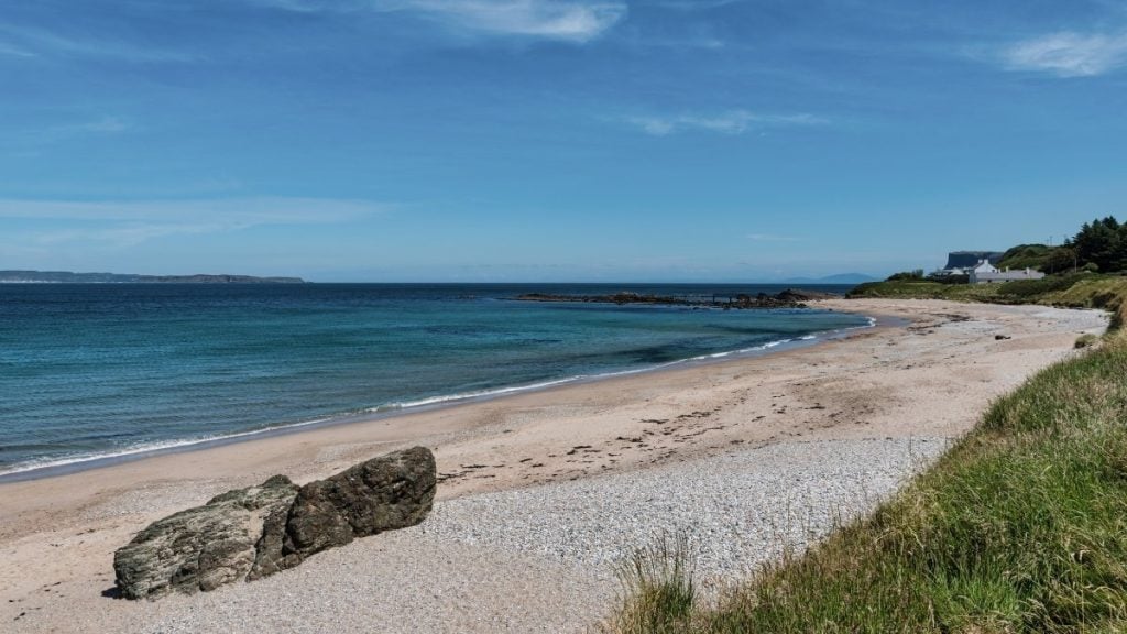 Ballycastle Beach with wide sandy shoreline and blue skies, County Antrim, Northern Ireland