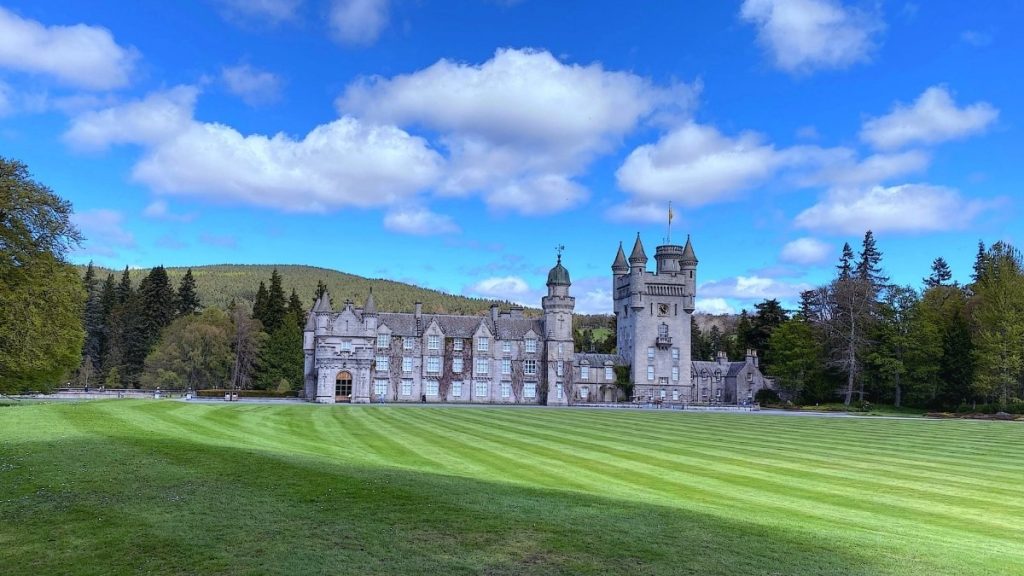 Balmoral Castle surrounded by trees and hills near Ballater in Royal Deeside, Scottish Highlands, Scotland
