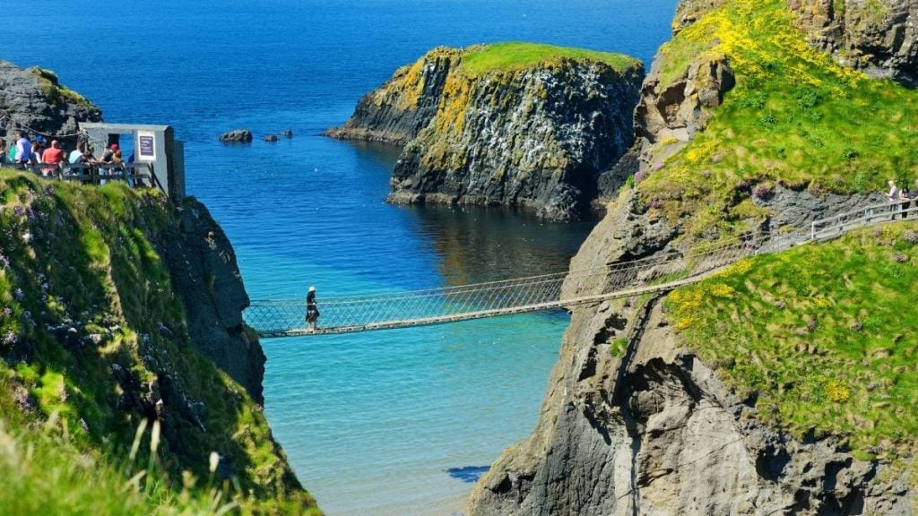 Carrick-a-Rede Rope Bridge suspended above the sea between cliffs and island, County Antrim, Northern Ireland