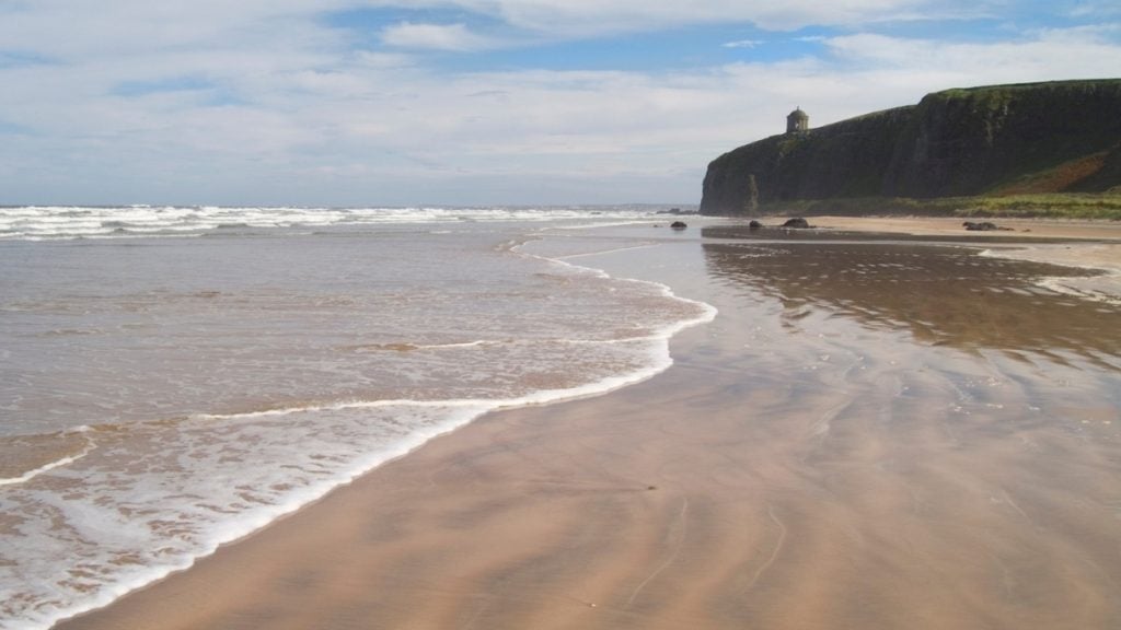 Downhill Strand with sandy beach, grassy dunes, and Mussenden Temple on the cliff above, County Londonderry, Northern Ireland