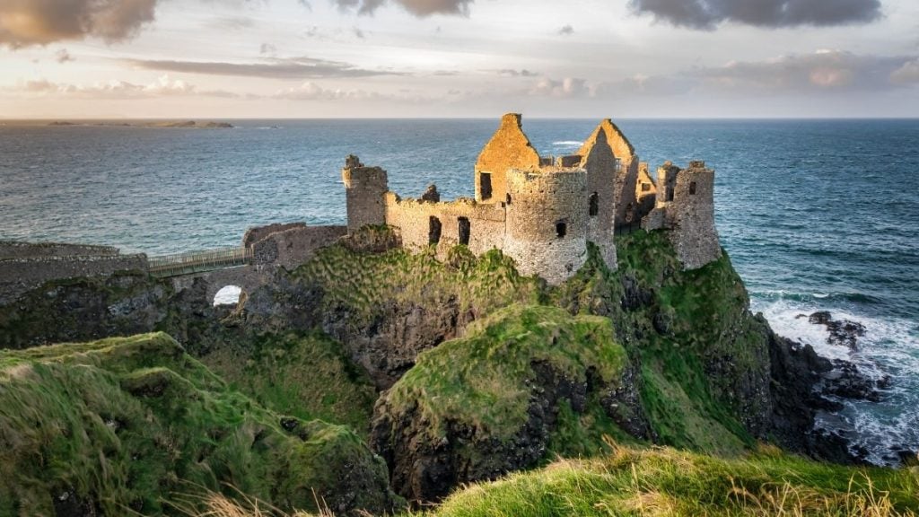 Ruins of Dunluce Castle perched on sea cliffs above the Atlantic Ocean, County Antrim, Northern Ireland