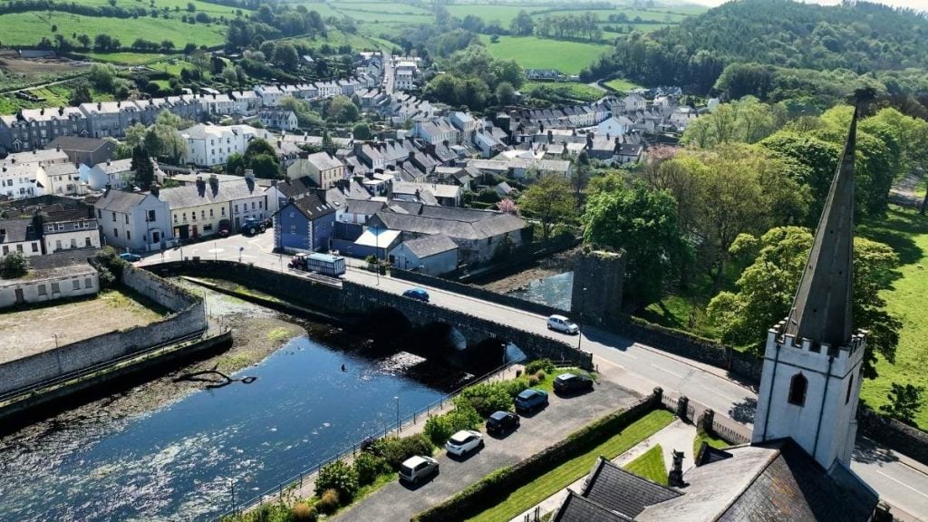 Glenarm Village with traditional cottages and castle estate nestled into the Antrim coastline, County Antrim, Northern Ireland