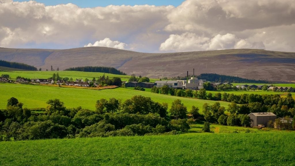 Glenlivet Distillery with surrounding hills and meadows in the Cairngorms, Scottish Highlands, Scotland