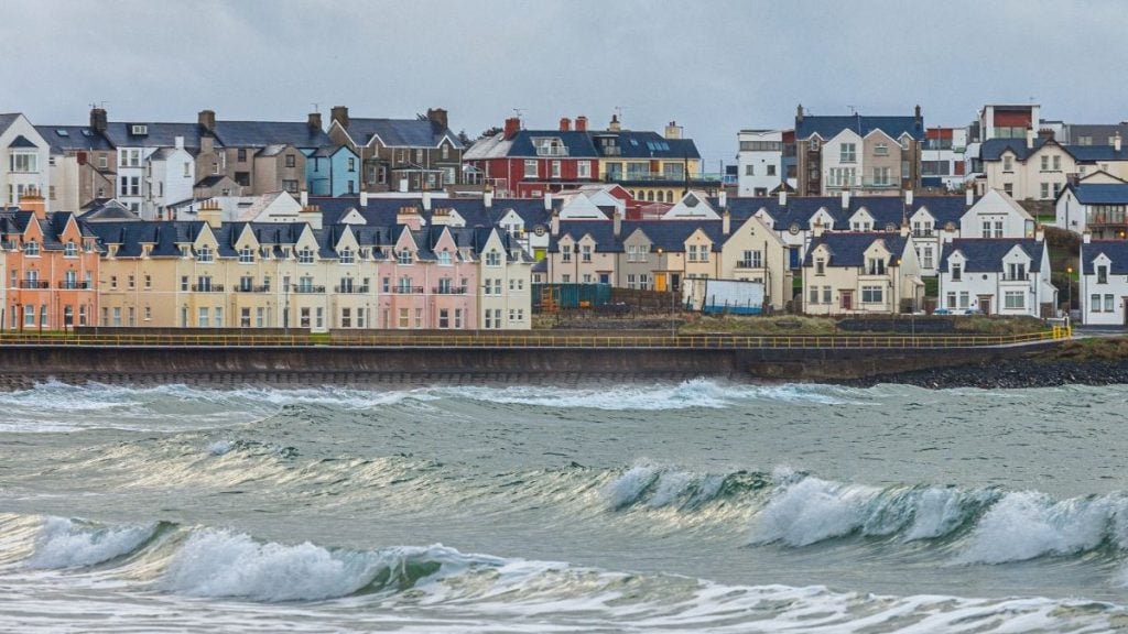Portrush, a charming seaside resort town located in County Antrim, Northern Ireland. Known for its stunning coastal views, sandy beaches, and vibrant atmosphere.
