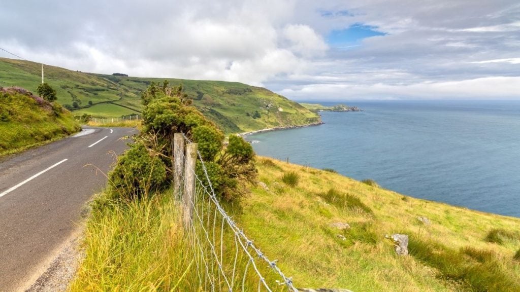 Winding coastal road to Torr Head with sea views and rugged hills, County Antrim, Northern Ireland