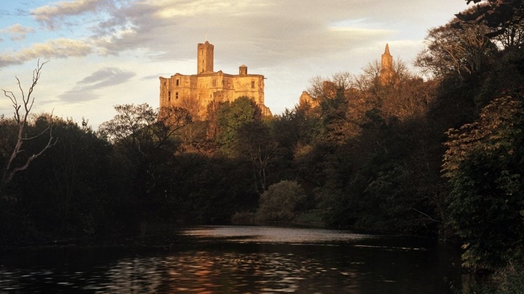 Warkworth Castle ruins overlooking a bend in the River Coquet, Northumberland, England
