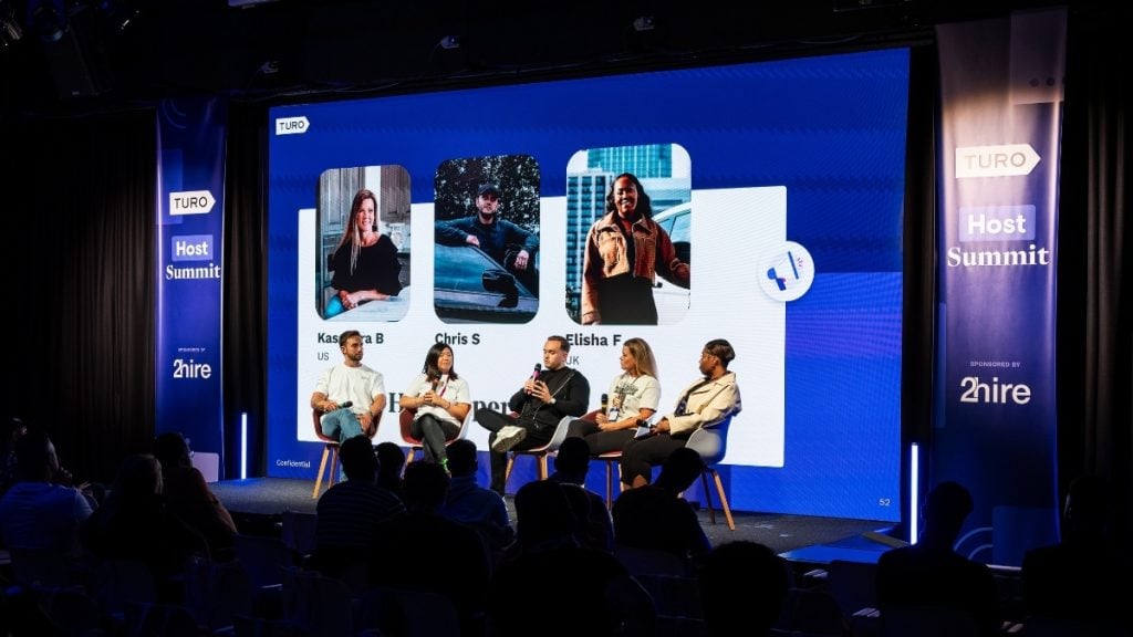 Three Turo Power Hosts seated on stage during a panel discussion at the first UK Host Summit, sharing advice and personal experiences on building successful Turo hosting businesses.