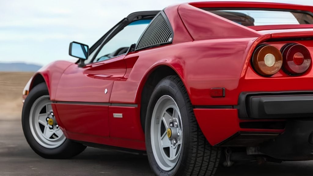 Rear view of a red 1982 Ferrari 308 GTS with signature twin circular taillights and Pininfarina styling
