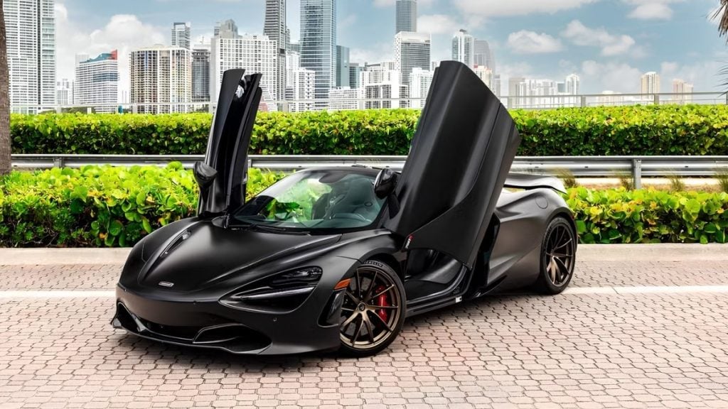 Black McLaren 720S supercar with dihedral doors open against the Miami skyline, Turo's August car of the month