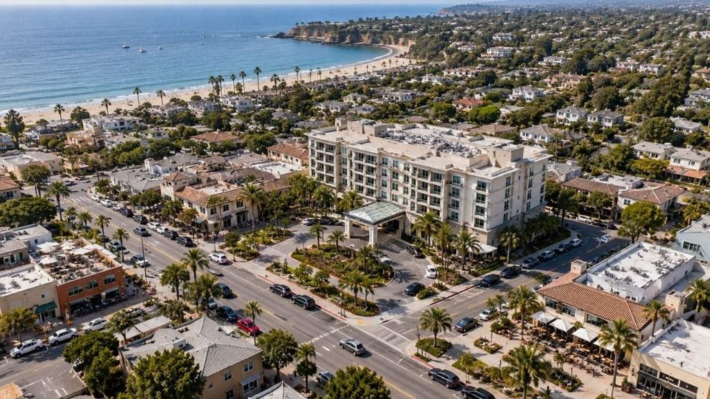 Aerial view of a hotel surrounded by homes, restaurants, and city streets
